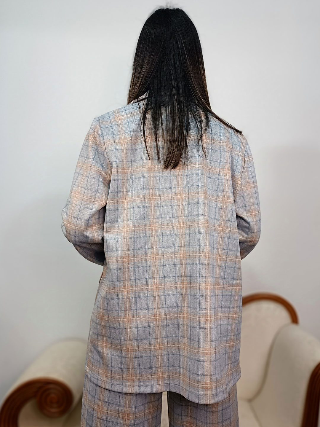 Vista posterior de la blazer de cuadros azul y rosa lisa.